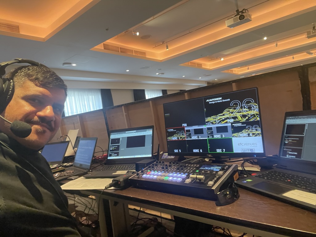 Luigi at the AV control desk at County Hall, with video switcher and multiview monitor